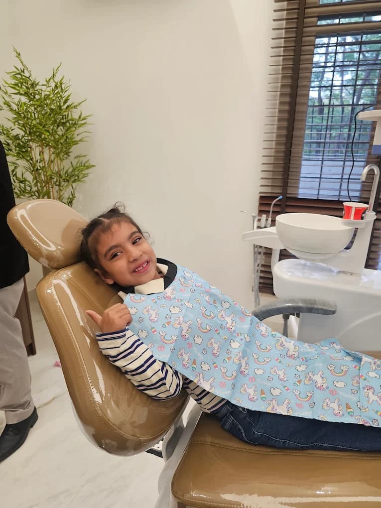 Child patient relaxed and smiling in the dental chair